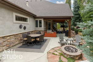 View of patio / terrace featuring a fire pit and outdoor dining space