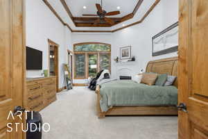 Bedroom with a towering ceiling, light colored carpet, coffered ceiling, ceiling fan, and ornamental molding