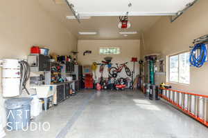 Garage featuring a central vacuum unit and a garage door opener