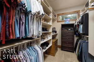 Spacious closet with light colored carpet