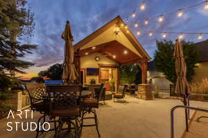 View of patio featuring outdoor dining area and a ceiling fan