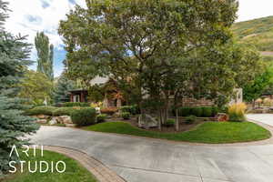 View of front of home featuring a front lawn and stone siding