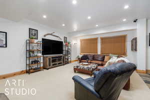 Living room with recessed lighting and carpet