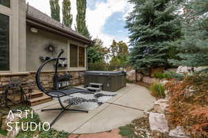 View of patio with a hot tub