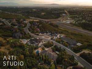 Aerial view of property and surrounding area with nearby suburban area and mountains