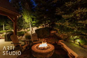 Patio at twilight featuring a patio, an outdoor fire pit, and area for grilling
