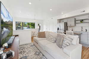 Living area featuring recessed lighting and light wood-type flooring