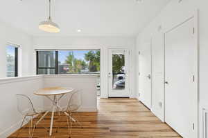 Dining room with light wood-style floors and recessed lighting