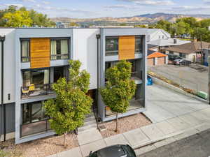 Contemporary house featuring a mountain view, stucco siding, and a residential view
