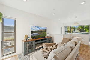 Living room with wood finished floors and recessed lighting