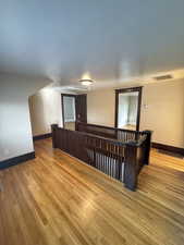 Spare room featuring baseboards and light wood-style flooring