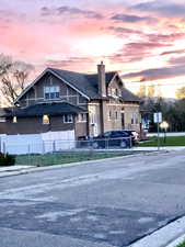 View of front of property with a chimney and stucco siding