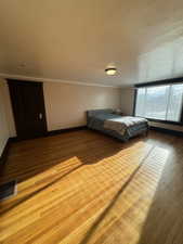 Bedroom with baseboards and wood finished floors