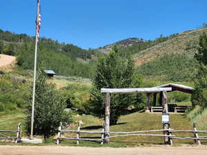 View of property's community with a lawn