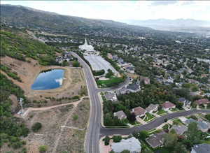 Aerial overview of property's location with a water and mountain view and nearby suburban area