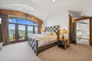 Bedroom with vaulted ceiling, recessed lighting, multiple windows, access to outside, and light carpet