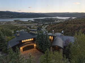 Aerial view at dusk of a forest view and a water and mountain view