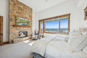 Bedroom with a fireplace and carpet flooring