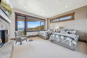 Carpeted bedroom with a fireplace, recessed lighting, access to outside, and tile walls