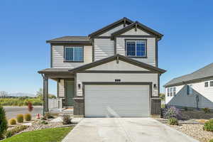 Craftsman inspired home featuring board and batten siding, covered porch, concrete driveway, a garage, and a shingled roof