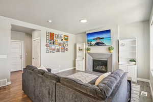Living room featuring hardwood / wood-style floors and a high end fireplace