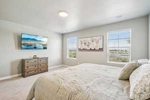 Bedroom featuring carpet flooring and baseboards