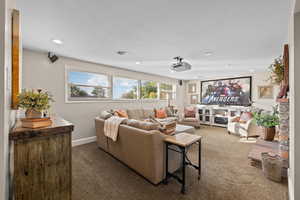 Lower Level Family Room with Expansive Windows, Gas Fireplace, Theatre Projector & Screen