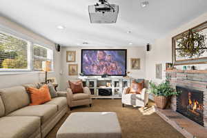 Lower Level Family Room with Expansive Windows, Gas Fireplace, Theatre Projector & Screen