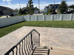 Fenced backyard featuring a residential view and a patio
