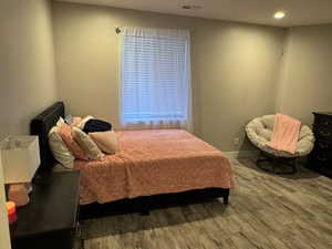 Bedroom featuring recessed lighting and wood finished floors