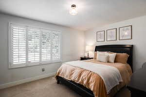 Bedroom featuring carpet floors and baseboards