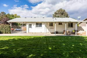 Back of house with a patio area and a gate