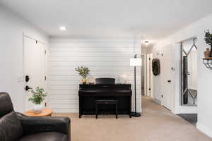 Sitting room with carpet flooring and ornamental molding