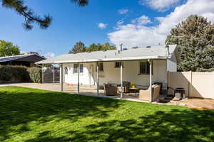 Rear view of property featuring outdoor lounge area and a patio