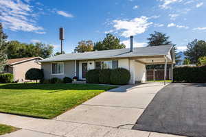 Ranch-style home featuring a carport, concrete driveway, and brick siding