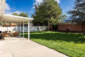 Fenced backyard with a patio area and an outdoor living space