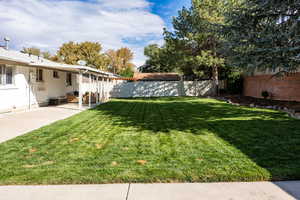 Fenced backyard featuring a patio
