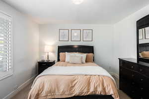 Carpeted bedroom with baseboards