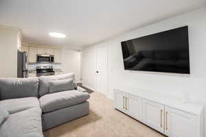 Living room with light carpet and baseboards