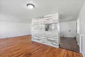 Shiplapped wall with view into the kitchen