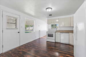 View of kitchen and side door leading to carport