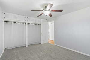 Bedroom 2 with ceiling fan and his/hers closet