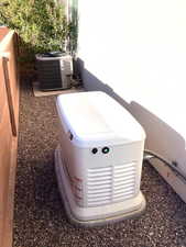 Exterior view of a Generac generator unit and a central AC unit