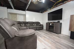 Living area featuring light wood finished floors and baseboards