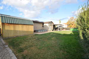 Fenced backyard with a patio area and a storage shed