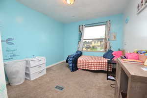 Bedroom featuring light colored carpet and baseboards
