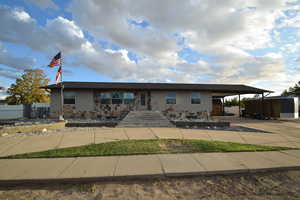 View of front of property featuring a carport and driveway