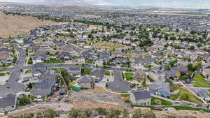 Aerial view of property and surrounding area featuring nearby suburban area