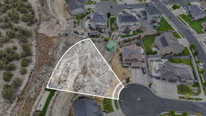 Aerial view of property and surrounding area featuring nearby suburban area and property boundaries highlighted