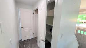 Hall with dark wood-type flooring